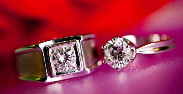 Couple Diamond Rings Closeup With A Blurred Red Ba 2022 11 11 06 55 41 Utc