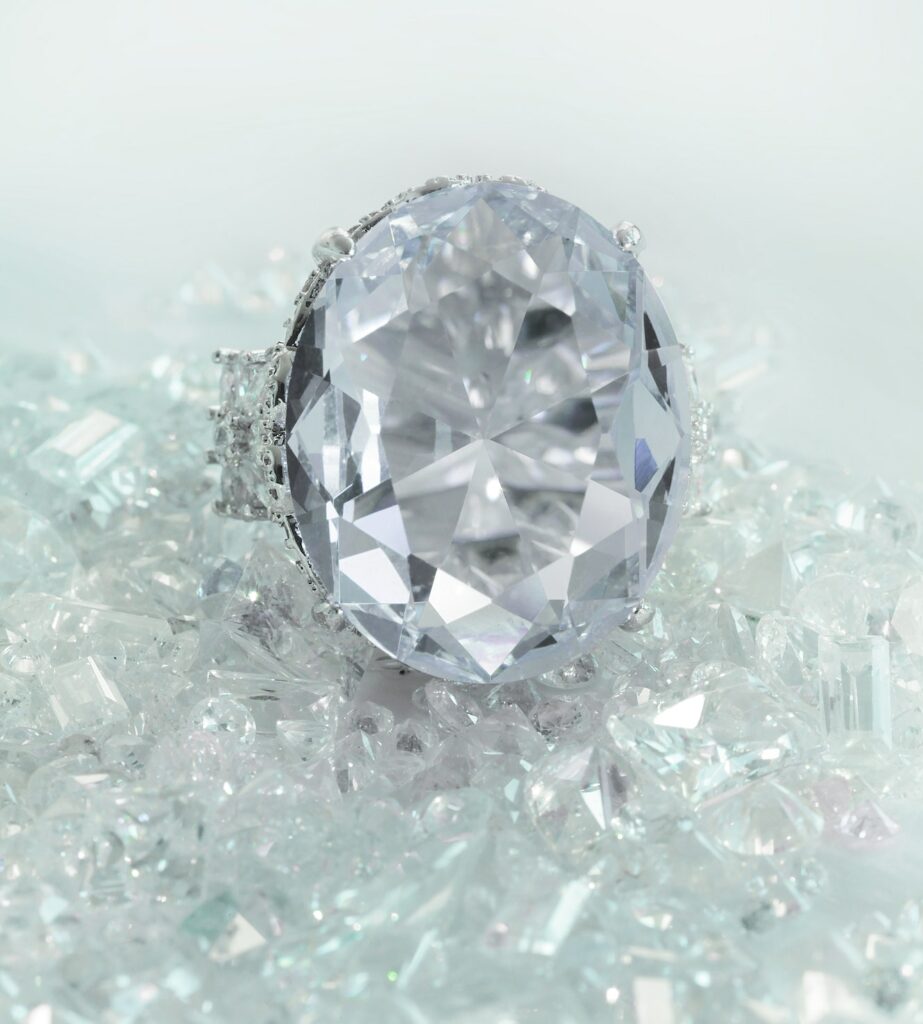 Beautiful Large Oval Diamond Engagement Wedding Ring Sitting On Diamonds Scattered Background