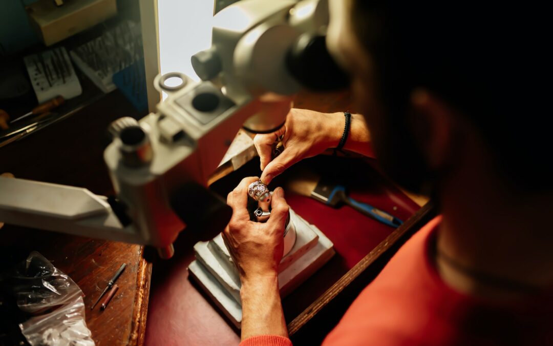 jeweller working with a microscope to ensure the diamond cut is of high quality