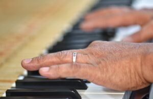 Man Wearing A Wedding Ring Playing Piano