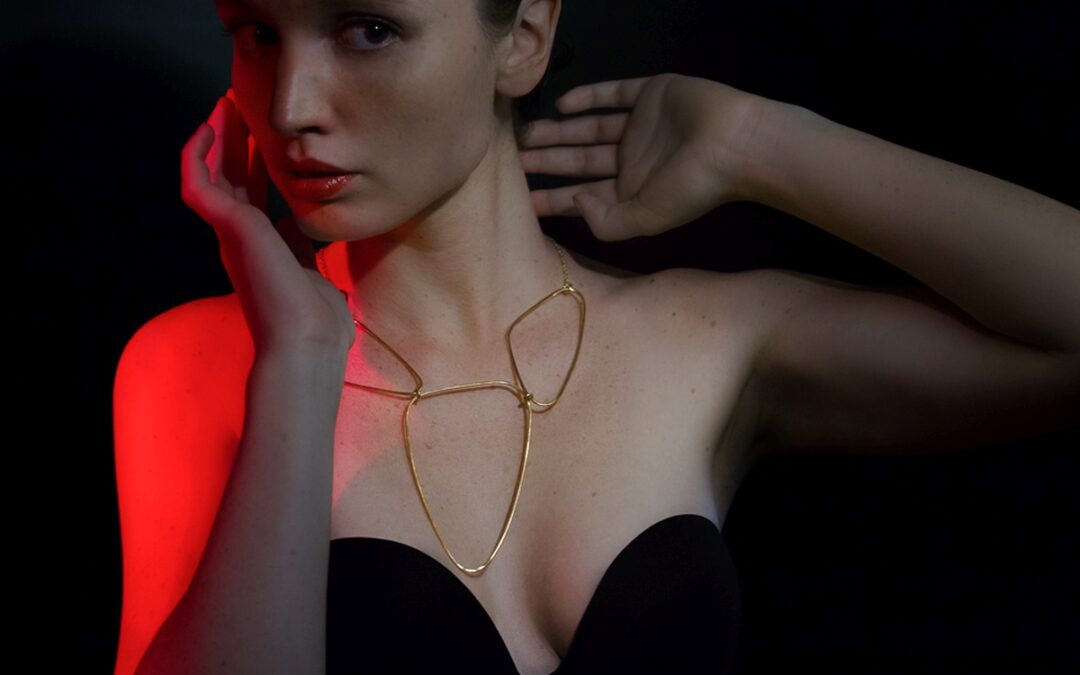 a model wearing a gold plated necklace from Eloise Fiorentino.